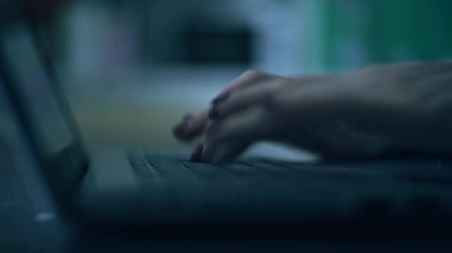 cinematic soft focus tracking shot of Woman working at home office hand on keyboard close up