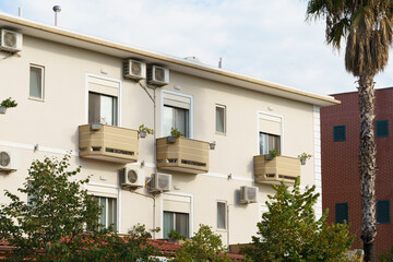 Light Mediterranean apartment block in Albania, soft geometry and open balcony lines. Ideal for rental stays, property buying, relocation, holiday living and real estate agency listings.