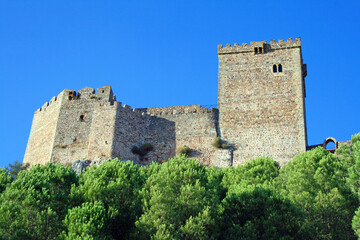 Historic Stone Castle Walls and Towers Against a Clear Blue Sky
