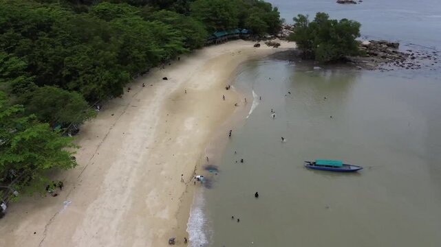 Aerial view of beautiful blue waters and white sandy beaches at Pelawan beach, Karimun Regency, Riau Islands Indonesia - drone flying over the beach