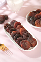 Xinjiang Dried Apricots in White Dishes - Candied Fruits on Pink Background