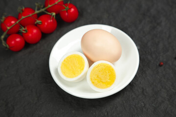 Hard Boiled Eggs with Cherry Tomatoes on Dark Slate Background - Healthy Breakfast Food