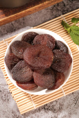Xinjiang Dried Candied Apricots in White Bowl on Bamboo Mat - Healthy Nutless Fruit Snack