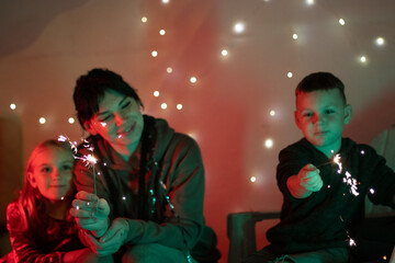 Happy family enjoying festive celebration with handheld sparklers