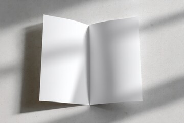 Fototapeta premium Top-down view of a white A4 brochure for layouts and designs