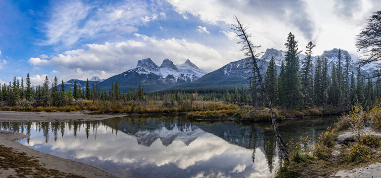 The Three Sisters mountain reflect on water in autumn. Beautiful natural scenery landscape at Canmore, Alberta, Canada.