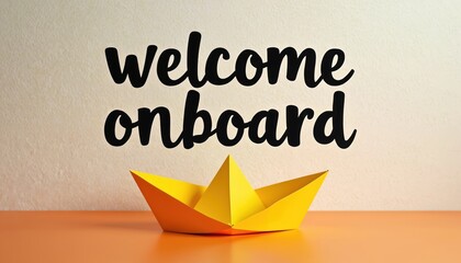 Naklejka na ściany i meble Yellow paper boat on orange surface. Above welcome onboard text. New beginnings, team joining, hiring, employee welcome. Image conveys warm, supportive, positive message for new staff.
