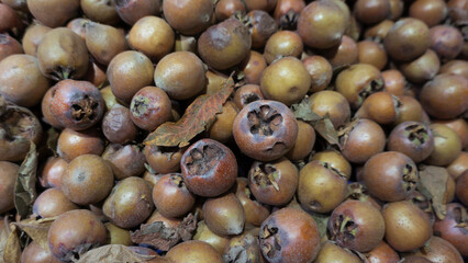 Ripe medlar fruits displayed for sale at market.