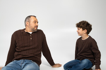 Fototapeta premium Cherished moments between a father and his son in a playful indoor setting