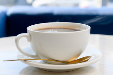 Aromatic strong Americano or espresso in a white cup with foam