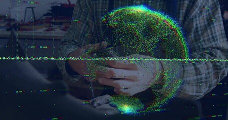 Holding woman manipulating smartphone at desk, wearing plaid shirt with digital globe and numbers