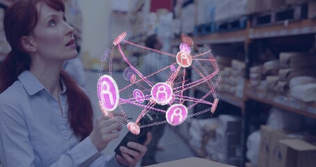 Holding tablet, woman in light shirt viewing holographic sphere over warehouse aisle, copy space