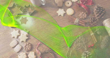 Obraz premium Sweeping neon-green mesh overlay spanning wood table, obscuring star cookies, pine cones, cinnamon