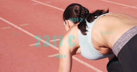 Crouching female runner preparing to sprint on red track with lanes, in sportswear, teal graphics