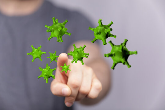 Hand pointing at green viruses, a visual representation of infection, disease spread, health concerns and pand