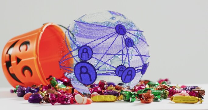 Showing translucent globe over white tabletop, orange jack-o'-lantern candy bucket spilling candies - Powered by Adobe