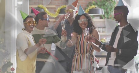 Clinking six adults lifting champagne flutes in home kitchen, wearing cone hats and shutter shades