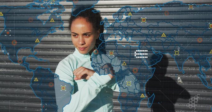 Adjusting woman in mint zip-up jacket crossing arms before metal shutter, digital map icons shadow