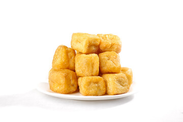 Crispy Fried Tofu Puffs on White Plate - Golden Bean Curd Cubes for Asian Cooking