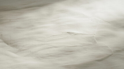 Obraz premium Abstract texture of light gray fabric with soft folds and subtle shadows