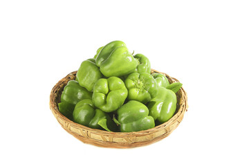 Fresh Green Bell Peppers in Wicker Basket Isolated on White Background