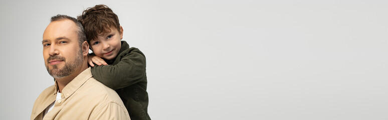 Father and son share a joyful moment of closeness and connection in a warm setting