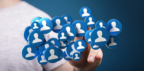 Abstract image of a person's hand holding floating social media icons representing networking, connections, and community.