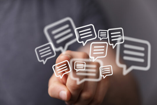 Hand touching digital speech bubbles, representing online communication, messaging, and conversations. Ideal for social media and internet conce - Powered by Adobe