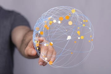 Close-up of a hand touching a futuristic digital sphere. The image represents global connectivity,...