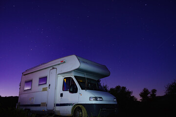 Night starry sky and camper rv.