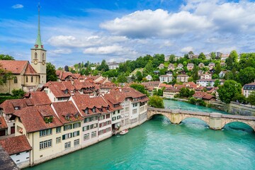 Stunning view of Bern, Switzerland, featuring the charming Old City with red-tiled roofs and the Aare River, embodying a perfect blend of history and culture in a picturesque travel destination.