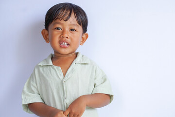 Smiling happily of an innocent Asian little boy in collared shirt isolated on white background with copy space