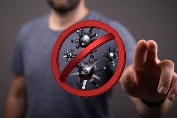 A man's hand pointing at a red stop sign with viruses, symbolizing stopping the spread of disease and virus co