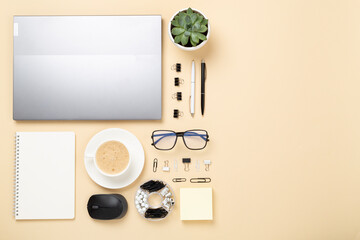 Naklejka premium Flat lay with laptop, notebook and cup of coffee on color background. Office workplace