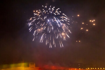 Blue fireworks over city in the night sky
