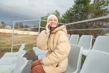 Fototapeta premium Portrait of a cheerful walking at stadium in cloudy autumn weather