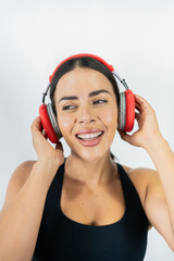 Healthy woman enjoying music on headphones while wearing sportswear