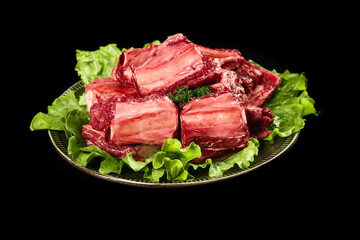 Raw Beef Inner Cut Steaks on Fresh Lettuce, Black Background
