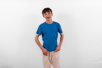 young casual dressed white male Gen Z model teenage boy with braces,  happy smile expressing relaxed confidence in positive happy way. plain background studio setting blue t-shirt