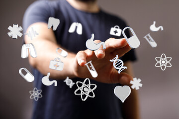 A person touching floating medical and healthcare icons, symbolizing technology and progress in medicine, well