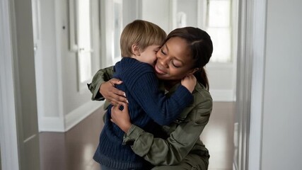 Child hugging his military mother.