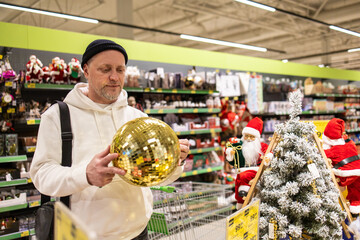 Man shopping in supermarket. Man buying Christmas toys