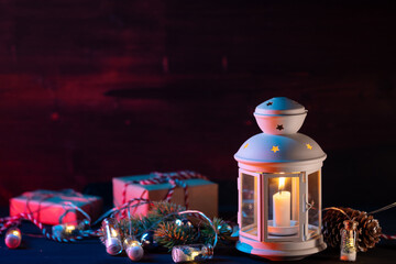 Christmas lantern with gifts, boxes and decorations on a wooden table. Copy space