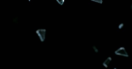 Glass shards exploding and scattering in ultra slow motion at 1000 fps. High-detail fragments suspended in air, creating dramatic cinematic impact visuals.
