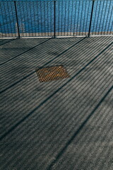 Long shadows of metal railings 