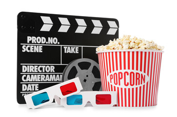 Fototapeta premium Tasty popcorn in takeaway bucket, 3D glasses, film reel and clapper isolated on white