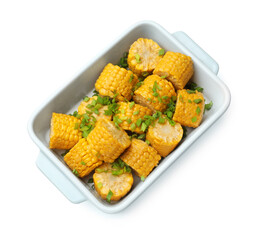 Pieces of boiled corncobs with green onion in baking dish isolated on white, top view