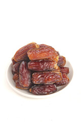 Golden Dried Dates Fruit on White Plate - Healthy Natural Snack Food Photography