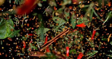 Flying mixed spices captured in mid-air against a dark background. Colorful chili, herbs, and pepper flakes suspended in motion, creating a dynamic culinary explosion. High-resolution macro photo.