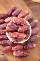Xinjiang Dried Dates in Bowl on Wooden Background - Golden Sweet Fruits for Healthy Eating